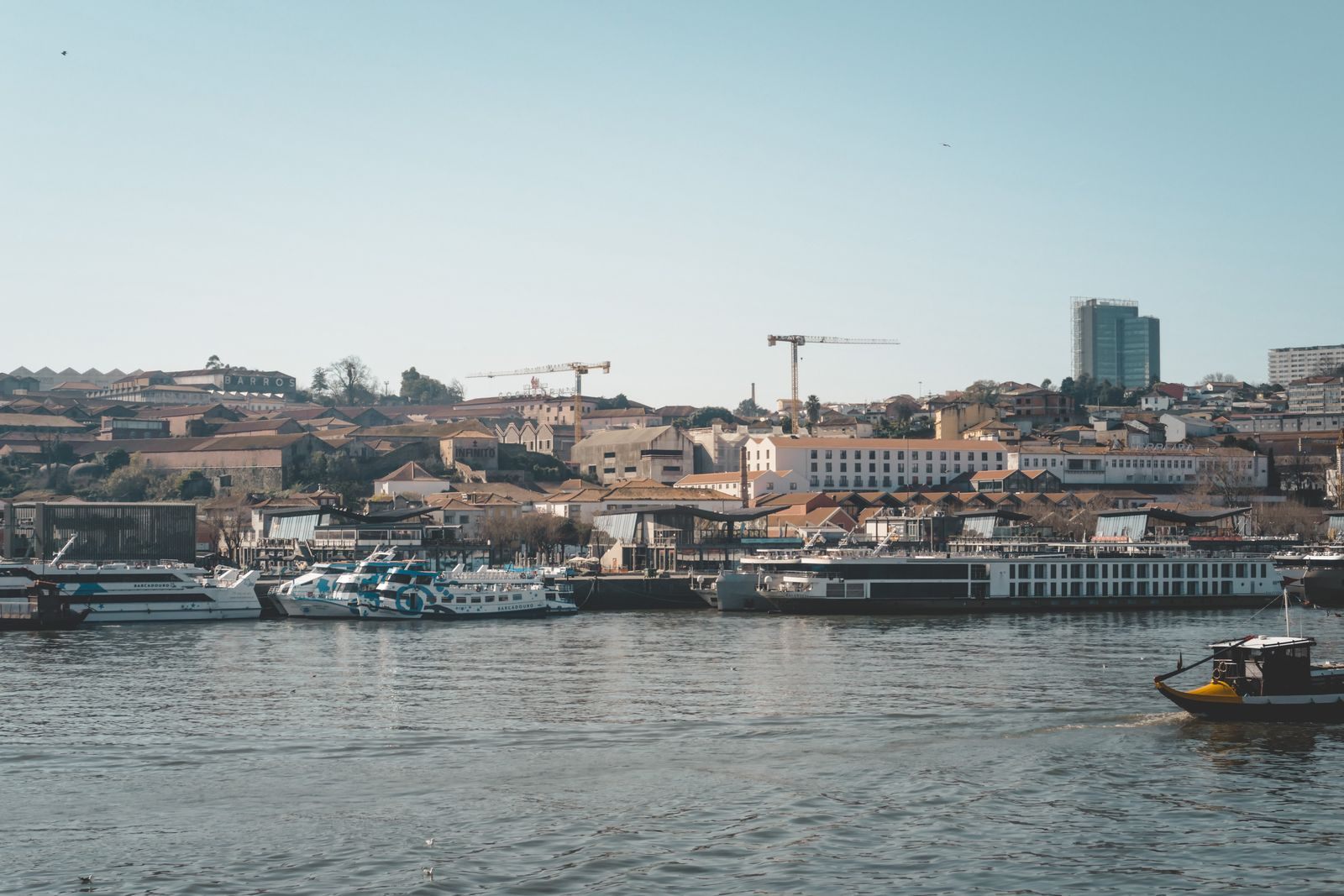 Boats moored along the Douro riverfront in Porto, Portugal, where travelers compare river cruise lines in Europe